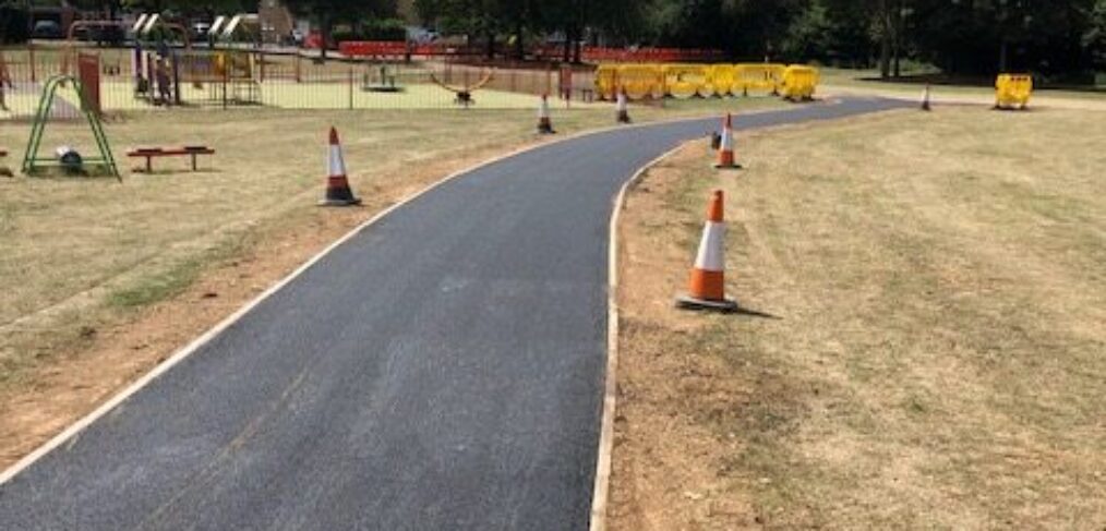 New asphalt footpath installation through park