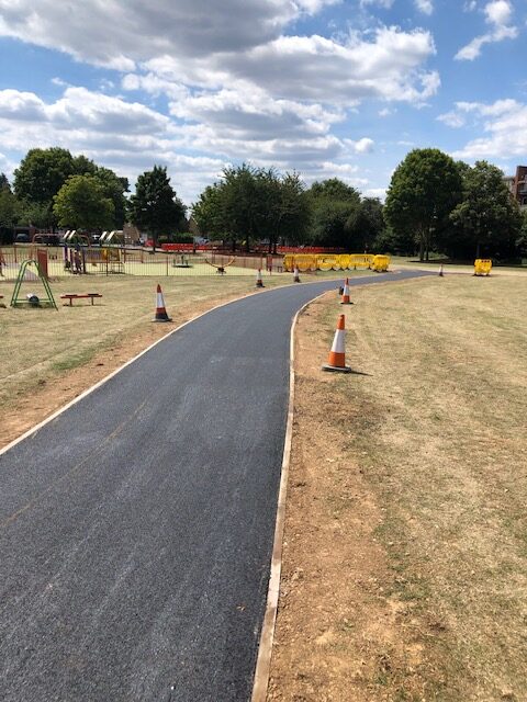 New asphalt footpath installation through park